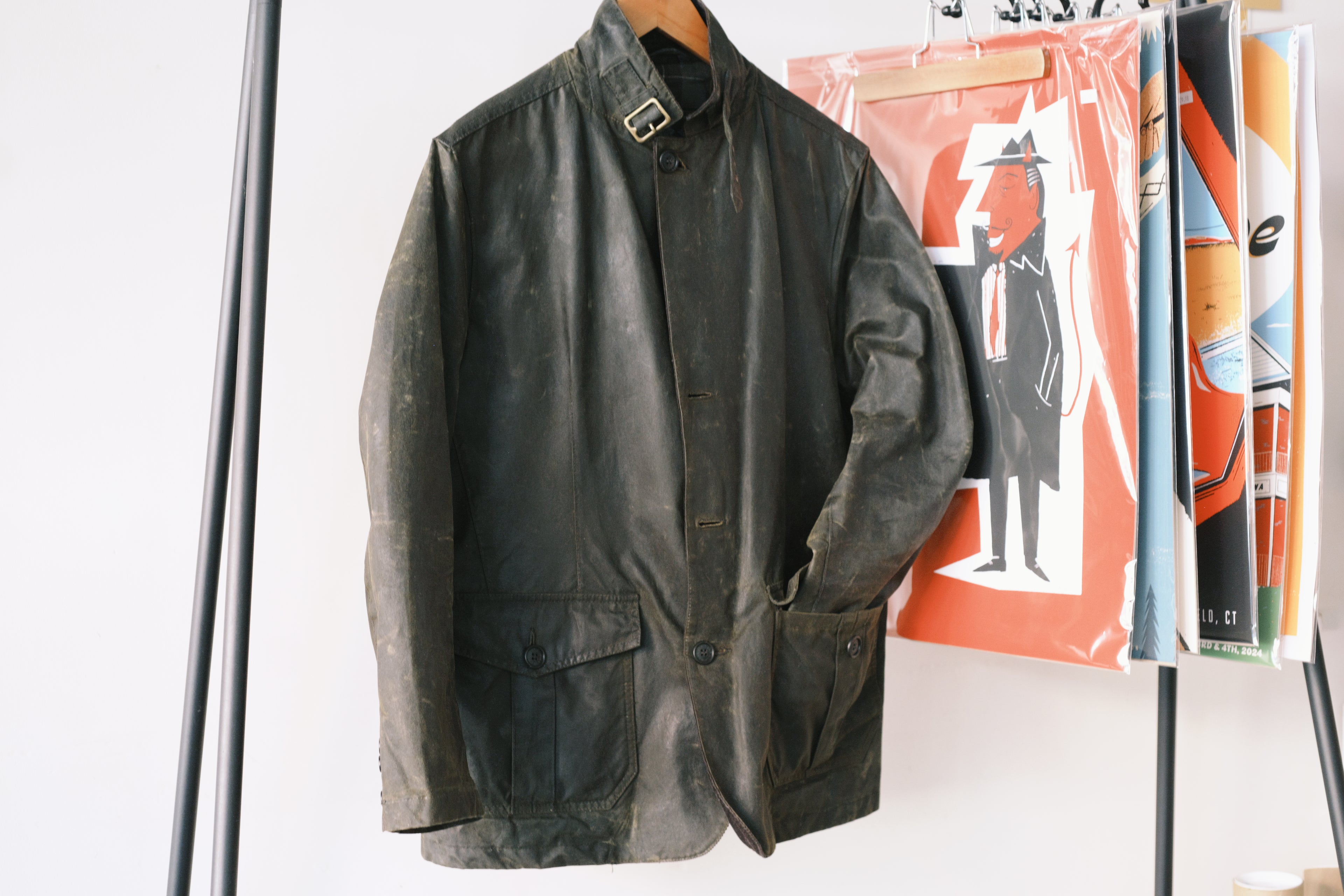 An image of a Barbour Lutz Waxed jacket hanging up.