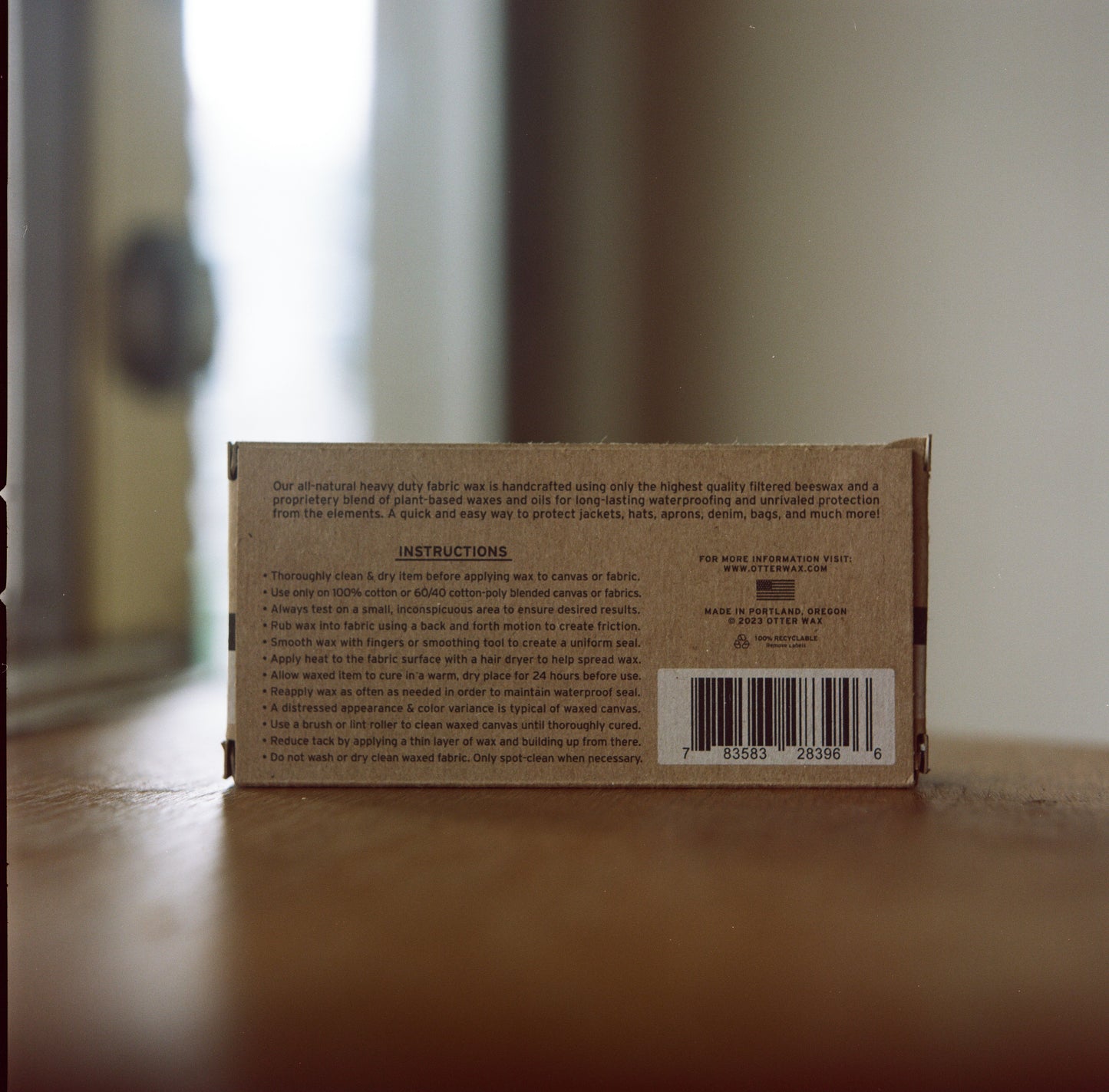 Cardboard box with text and a barcode on a wooden surface