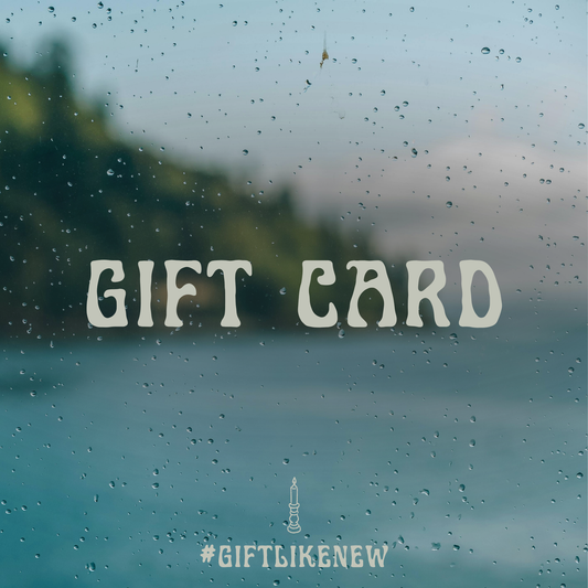 An image with the text "Gift Card" over a window covered in raindrops.